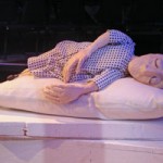 A person peacefully sleeping on a pillow in a dimly lit room.